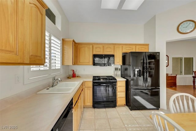 10532 Sea Palms Ave, Las Vegas, NV 89134 - kitchen featuring black appliances, light countertops, light brown cabinetry, and light tile patterned floors