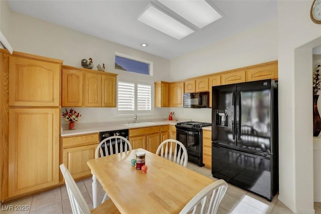 10532 Sea Palms Ave, Las Vegas, NV 89134 - kitchen with black appliances, light brown cabinets, light tile patterned flooring, light countertops, and recessed lighting