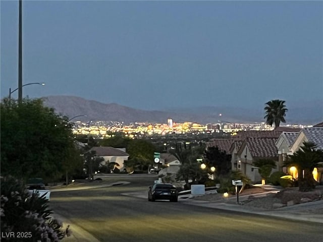 10532 Sea Palms Ave, Las Vegas, NV 89134 - view of asphalt road with street lighting, traffic signs, sidewalks, and a mountain view