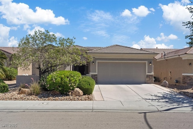 2108 Willow Wren Dr, North Las Vegas, NV 89084 - view of front of property featuring stone siding, an attached garage, driveway, and stucco siding