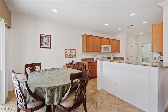 2108 Willow Wren Dr, North Las Vegas, NV 89084 - dining space with light tile patterned floors, recessed lighting, and crown molding