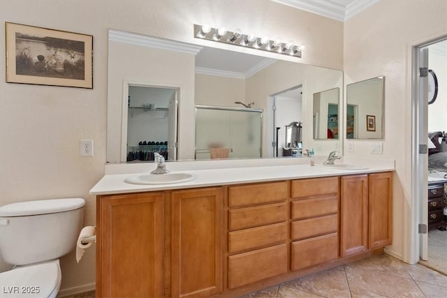 2108 Willow Wren Dr, North Las Vegas, NV 89084 - bathroom with ornamental molding, a stall shower, double vanity, toilet, and tile patterned floors