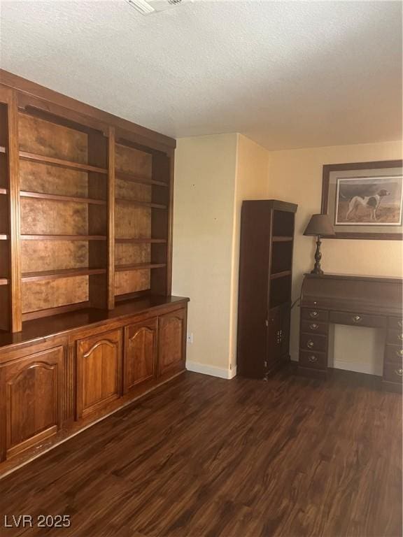 3394 Brookfield Dr, Las Vegas, NV 89120 - unfurnished living room featuring dark wood-style flooring, a textured ceiling, and baseboards