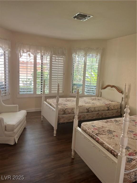 3394 Brookfield Dr, Las Vegas, NV 89120 - bedroom featuring multiple windows, dark wood finished floors, and baseboards