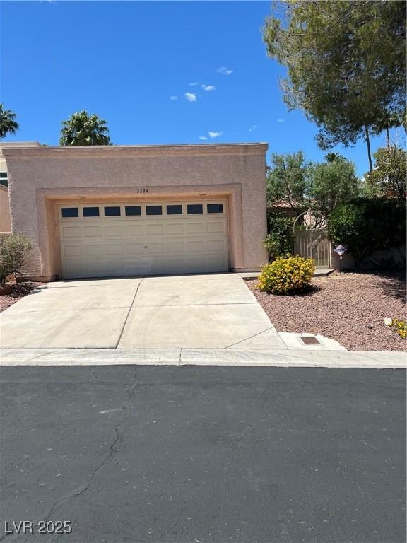 3394 Brookfield Dr, Las Vegas, NV 89120 - view of front of property featuring driveway, a garage, and stucco siding