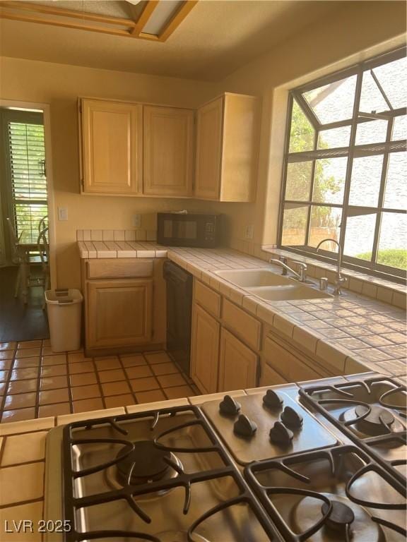 3394 Brookfield Dr, Las Vegas, NV 89120 - kitchen featuring tile counters, dishwasher, black microwave, a sink, and light tile patterned floors
