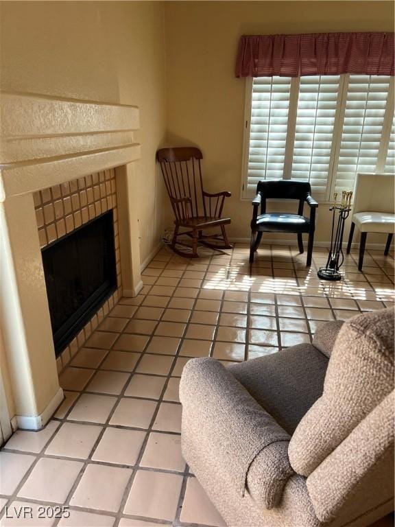 3394 Brookfield Dr, Las Vegas, NV 89120 - living area with light tile patterned floors, a fireplace, and baseboards