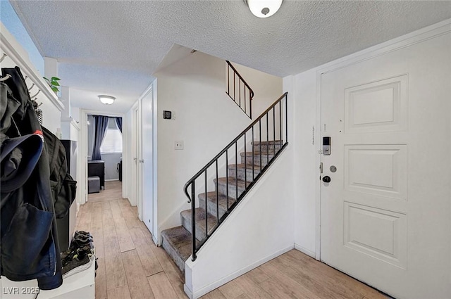 3018 Burnham Ave, Las Vegas, NV 89169 - foyer featuring light wood-style floors, a textured ceiling, and stairway