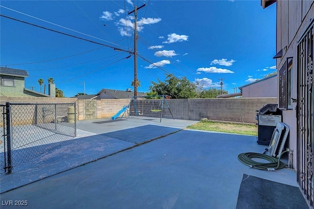 3018 Burnham Ave, Las Vegas, NV 89169 - view of patio with a playground, a grill, and a fenced backyard