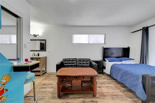 3018 Burnham Ave, Las Vegas, NV 89169 - bedroom with light wood-style floors and a textured ceiling