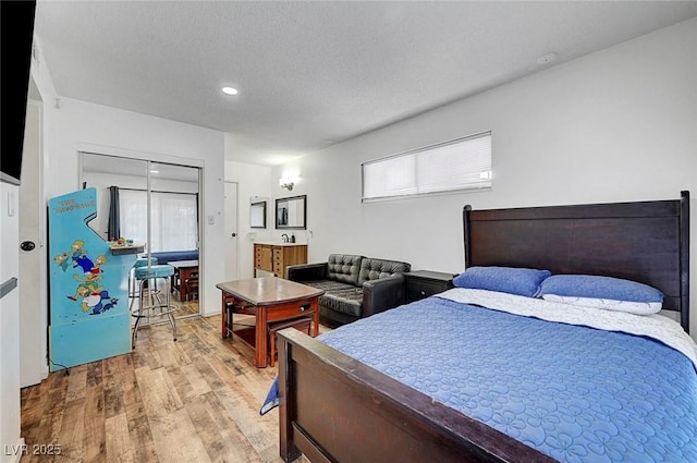 3018 Burnham Ave, Las Vegas, NV 89169 - bedroom with wood finished floors, recessed lighting, a textured ceiling, and a closet