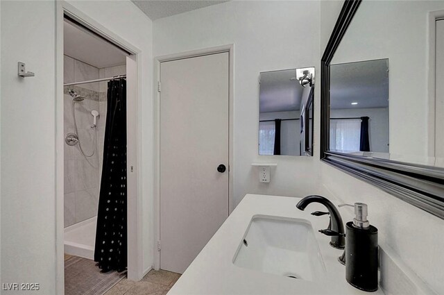3018 Burnham Ave, Las Vegas, NV 89169 - bathroom featuring a sink, a tile shower, and tile patterned floors