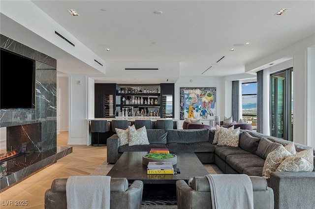 living area with a premium fireplace and bar area