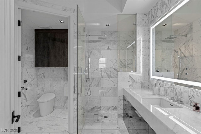 full bathroom with toilet, a marble finish shower, tile walls, marble finish floors, and vanity