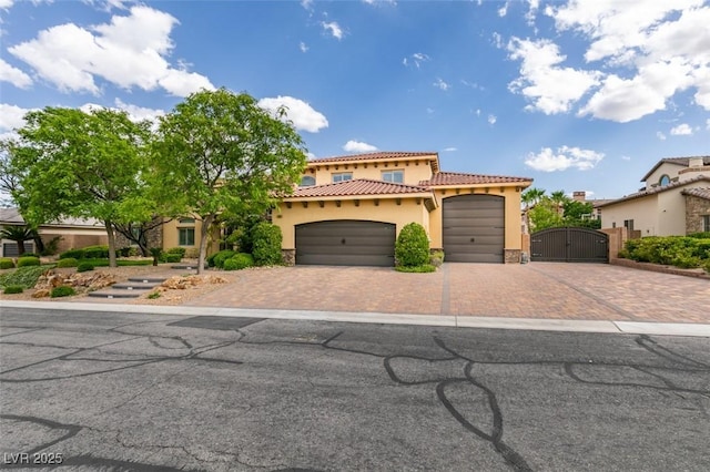 9749 Glistening Brook Ct, Las Vegas, NV 89149 - mediterranean / spanish-style house featuring a gate, stucco siding, decorative driveway, a tiled roof, and a garage