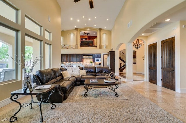 9749 Glistening Brook Ct, Las Vegas, NV 89149 - living area with arched walkways, ceiling fan, recessed lighting, high vaulted ceiling, and baseboards