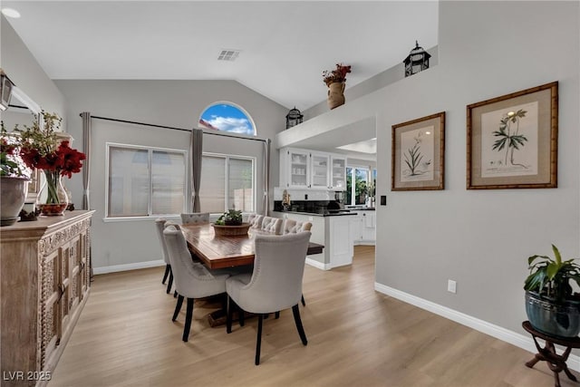 4617 Mancilla St, Las Vegas, NV 89130 - dining space featuring lofted ceiling, light wood-style floors, baseboards, and plenty of natural light