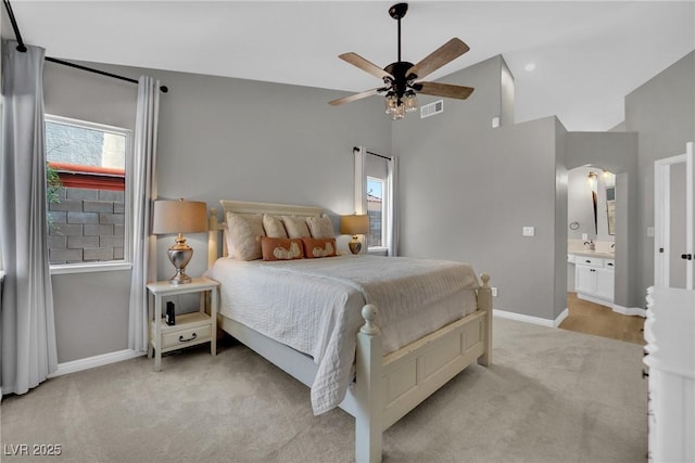 4617 Mancilla St, Las Vegas, NV 89130 - bedroom with light colored carpet, arched walkways, ensuite bath, ceiling fan, and high vaulted ceiling