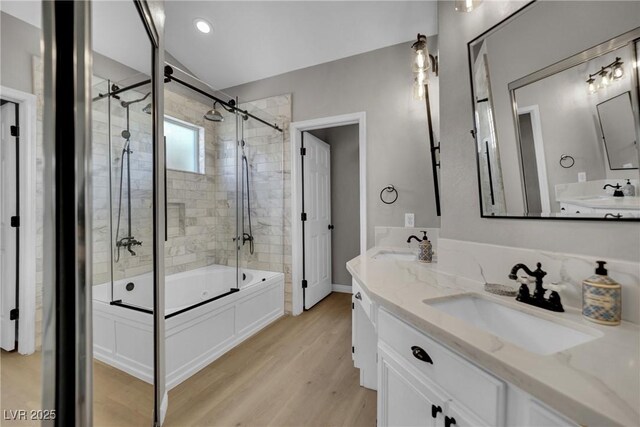 4617 Mancilla St, Las Vegas, NV 89130 - full bath featuring shower / bath combination with glass door, wood finished floors, and double vanity