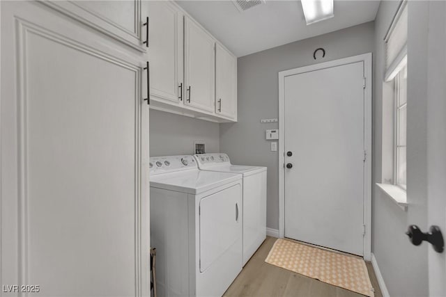 4617 Mancilla St, Las Vegas, NV 89130 - laundry room with cabinet space, washer and clothes dryer, light wood-type flooring, and baseboards