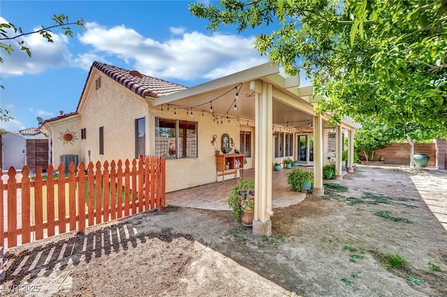 4617 Mancilla St, Las Vegas, NV 89130 - view of property exterior featuring stucco siding, cooling unit, a patio area, and a tiled roof