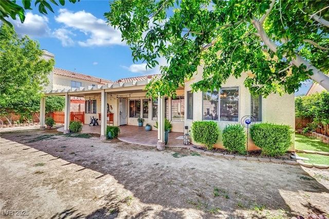 4617 Mancilla St, Las Vegas, NV 89130 - back of property featuring stucco siding, a patio, a pergola, and fence