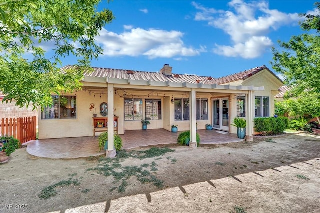 4617 Mancilla St, Las Vegas, NV 89130 - back of house featuring a tiled roof, a patio area, a chimney, fence, and stucco siding