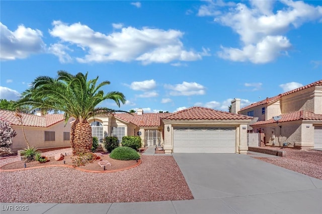 4617 Mancilla St, Las Vegas, NV 89130 - mediterranean / spanish home featuring a tiled roof, a garage, stucco siding, and driveway