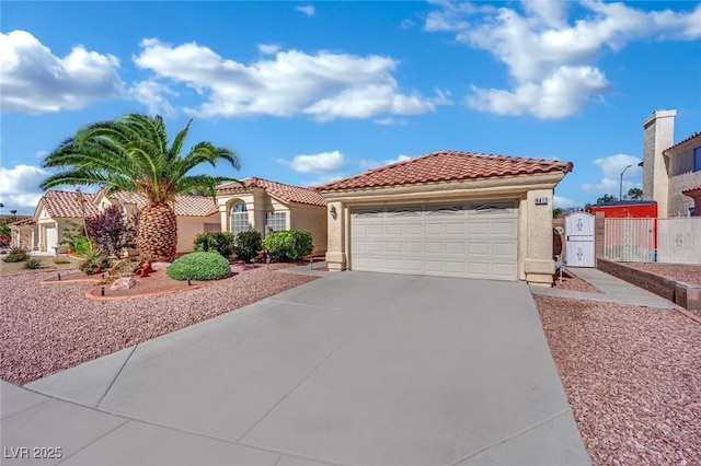4617 Mancilla St, Las Vegas, NV 89130 - mediterranean / spanish-style home with stucco siding, a tiled roof, an attached garage, driveway, and fence