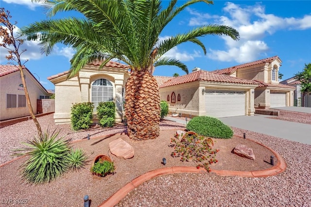 4617 Mancilla St, Las Vegas, NV 89130 - mediterranean / spanish house featuring a tile roof, a garage, driveway, and stucco siding