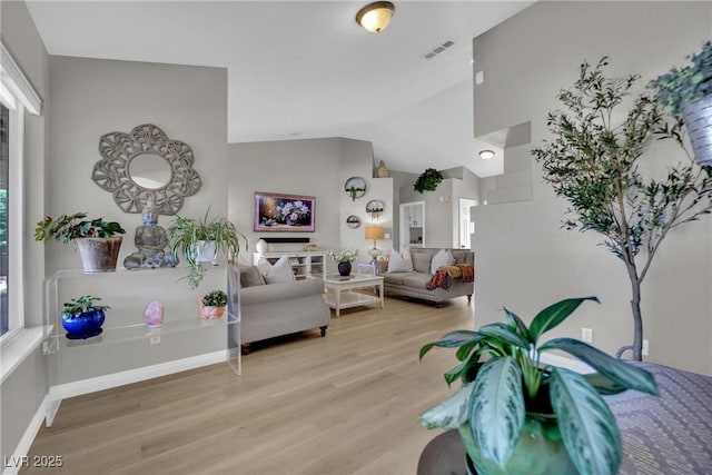 4617 Mancilla St, Las Vegas, NV 89130 - living area featuring wood finished floors, vaulted ceiling, and baseboards