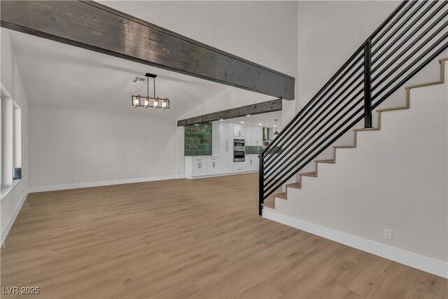 4061 W Eldorado Ln, Las Vegas, NV 89139 - stairs featuring wood finished floors, baseboards, a chandelier, and a towering ceiling