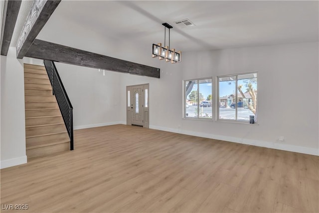 4061 W Eldorado Ln, Las Vegas, NV 89139 - unfurnished living room featuring stairs, light wood-style floors, a chandelier, and baseboards