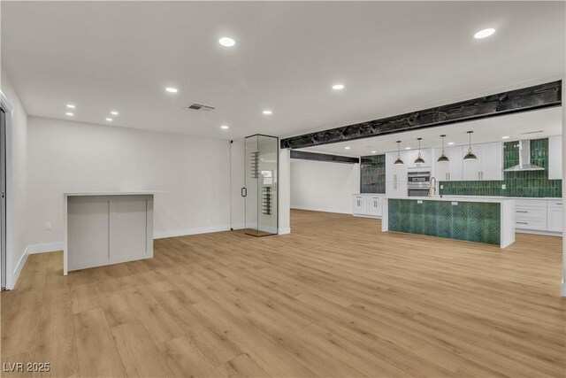4061 W Eldorado Ln, Las Vegas, NV 89139 - unfurnished living room with light wood-style floors, recessed lighting, a sink, and baseboards