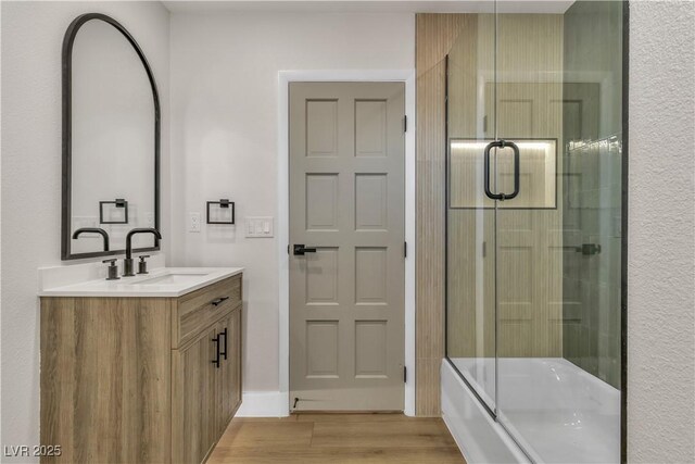 4061 W Eldorado Ln, Las Vegas, NV 89139 - full bath featuring wood finished floors, vanity, and shower / bath combination with glass door