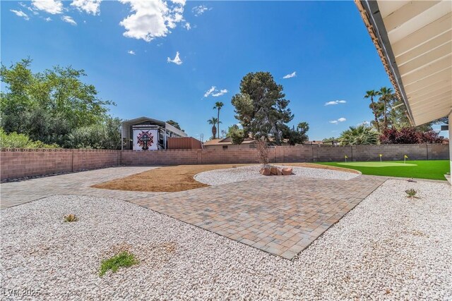 4061 W Eldorado Ln, Las Vegas, NV 89139 - view of patio / terrace with a fenced backyard and an area to practice putting