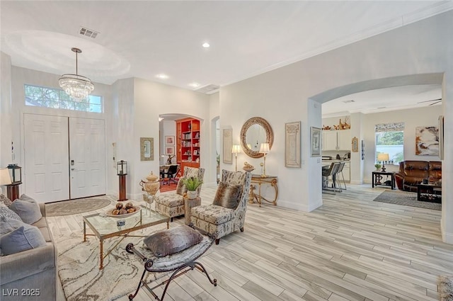 729 Sir James Bridge Way, Las Vegas, NV 89145 - living area with arched walkways, light wood finished floors, baseboards, a chandelier, and recessed lighting