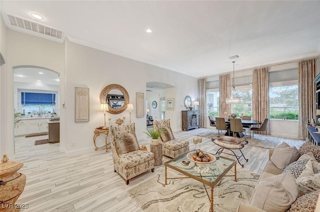 729 Sir James Bridge Way, Las Vegas, NV 89145 - living room featuring arched walkways, baseboards, light wood finished floors, crown molding, and recessed lighting