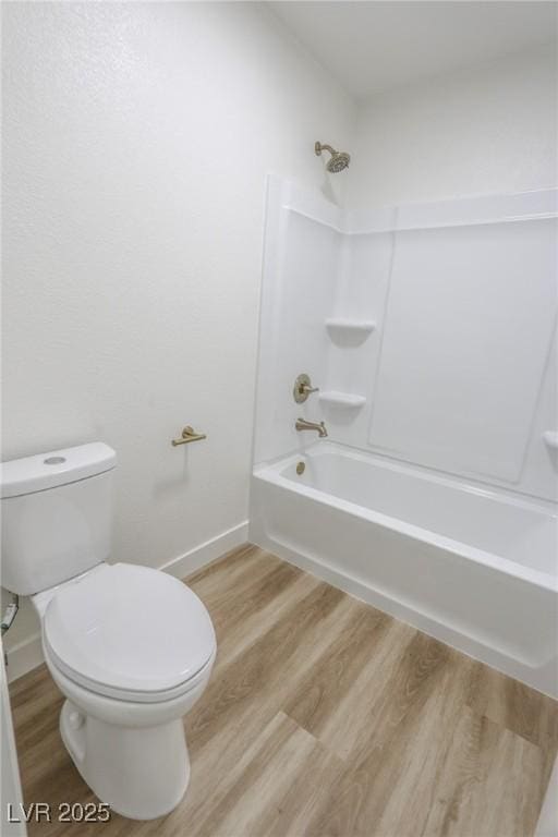 6842 Greengrove Dr, Las Vegas, NV 89103 - bathroom featuring wood finished floors, toilet, baseboards, and bathing tub / shower combination