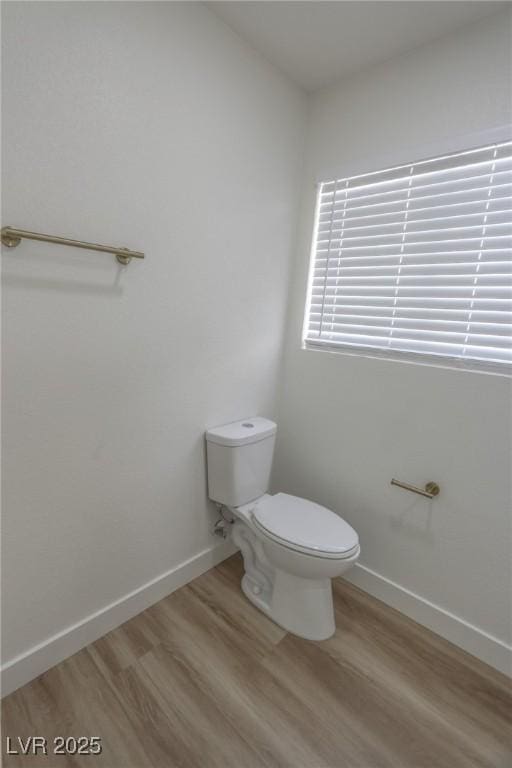 6842 Greengrove Dr, Las Vegas, NV 89103 - bathroom featuring wood finished floors, toilet, and baseboards