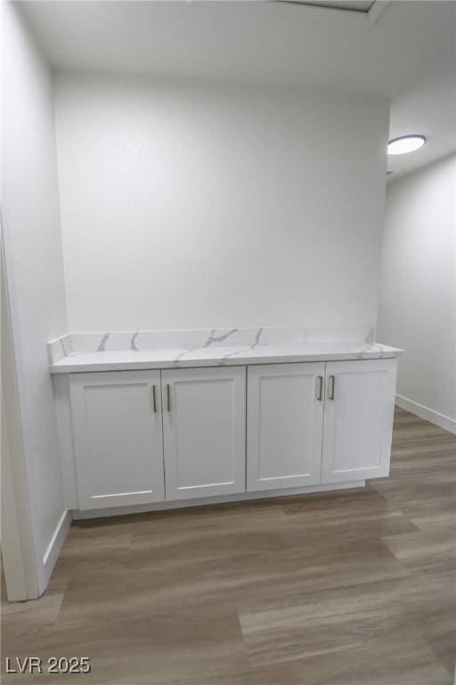 6842 Greengrove Dr, Las Vegas, NV 89103 - bathroom featuring baseboards and wood finished floors
