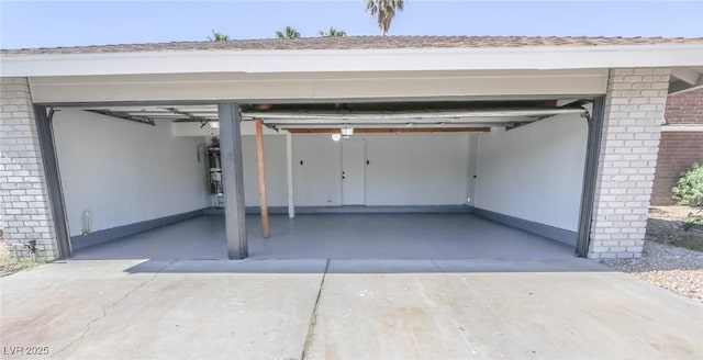 6842 Greengrove Dr, Las Vegas, NV 89103 - garage featuring driveway and strapped water heater