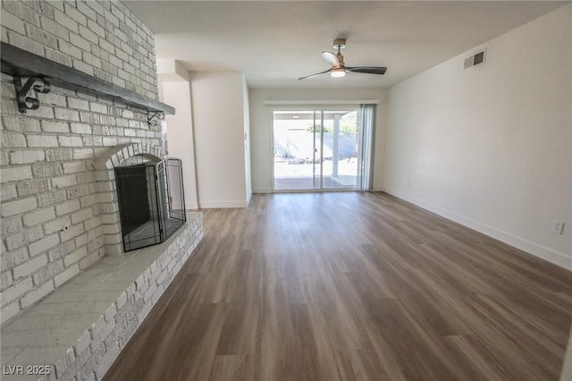 6842 Greengrove Dr, Las Vegas, NV 89103 - unfurnished living room featuring a ceiling fan, a brick fireplace, wood finished floors, and baseboards