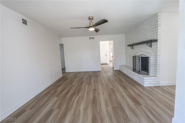 6842 Greengrove Dr, Las Vegas, NV 89103 - unfurnished living room featuring a brick fireplace, a ceiling fan, wood finished floors, and baseboards