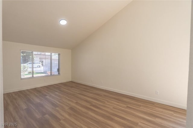 6842 Greengrove Dr, Las Vegas, NV 89103 - empty room with vaulted ceiling, baseboards, and wood finished floors
