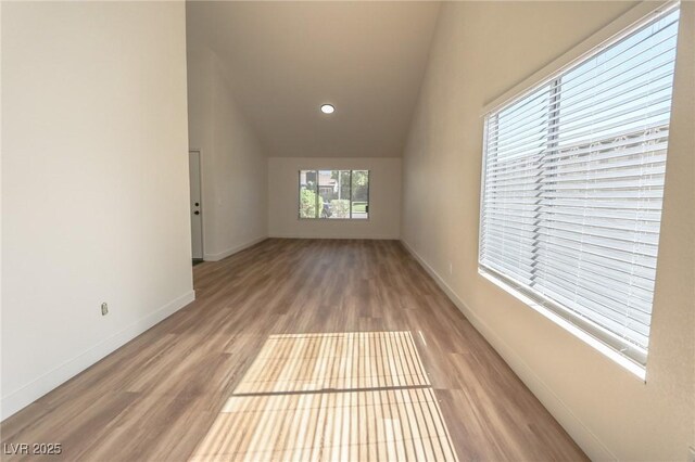 6842 Greengrove Dr, Las Vegas, NV 89103 - empty room with baseboards, vaulted ceiling, wood finished floors, and recessed lighting