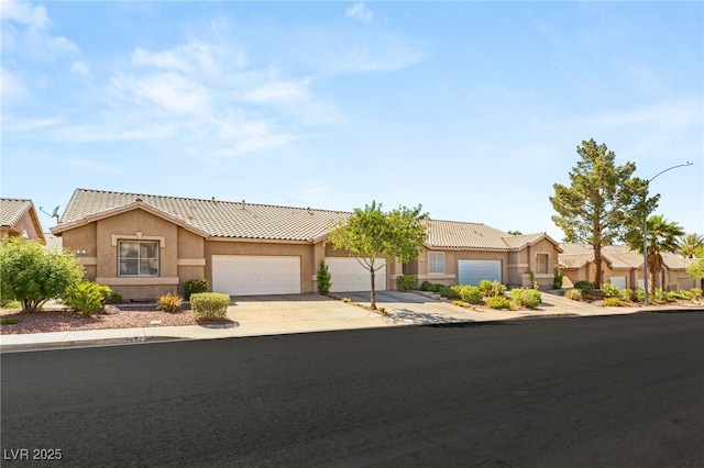 199 Bailey Island Dr, Henderson, NV 89074 - ranch-style house featuring concrete driveway, a garage, stucco siding, and a tiled roof