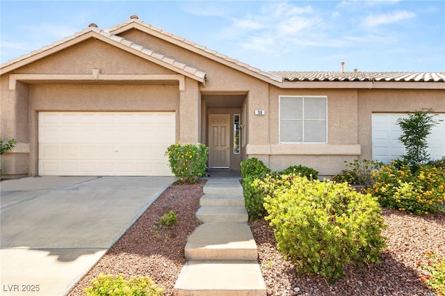 199 Bailey Island Dr, Henderson, NV 89074 - view of front of home featuring stucco siding, driveway, a garage, and a tiled roof