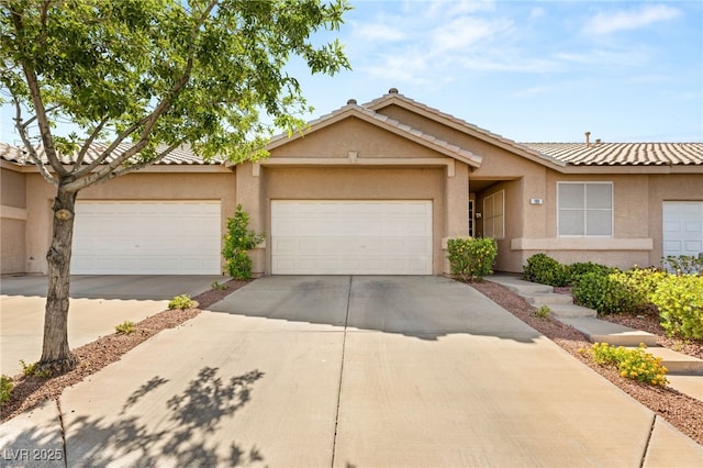 199 Bailey Island Dr, Henderson, NV 89074 - view of front of home featuring stucco siding, driveway, and an attached garage