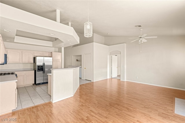 199 Bailey Island Dr, Henderson, NV 89074 - kitchen featuring stainless steel fridge with ice dispenser, ceiling fan, light countertops, light wood-type flooring, and arched walkways